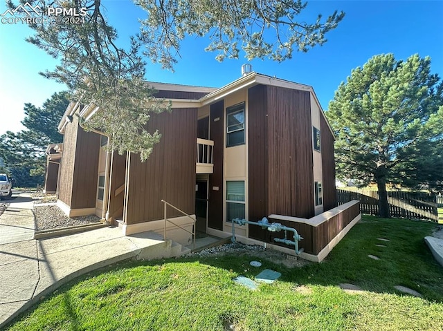 rear view of house featuring a yard