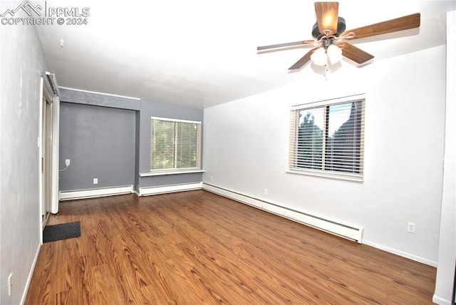 unfurnished bedroom featuring baseboard heating, dark wood-type flooring, and ceiling fan