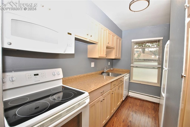 kitchen with sink, white appliances, baseboard heating, light brown cabinetry, and dark hardwood / wood-style flooring