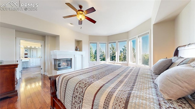 bedroom featuring wood-type flooring, ceiling fan, and connected bathroom