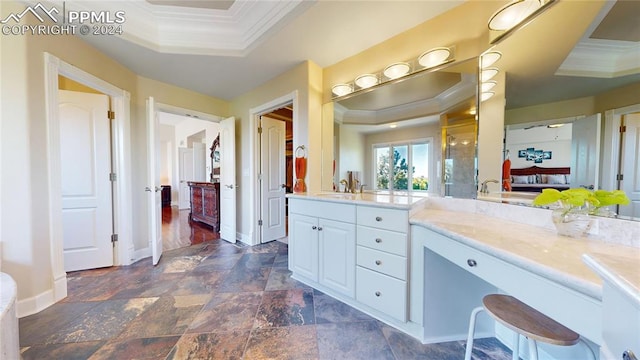 bathroom with wood-type flooring, vanity, a tray ceiling, and ornamental molding