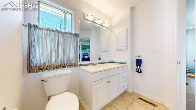 bathroom featuring vanity, toilet, and tile patterned floors