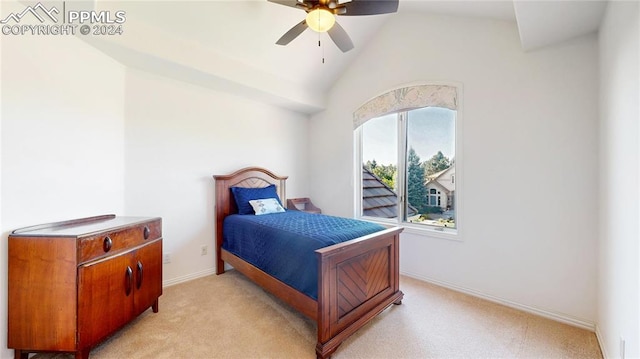 bedroom with ceiling fan, light colored carpet, and vaulted ceiling