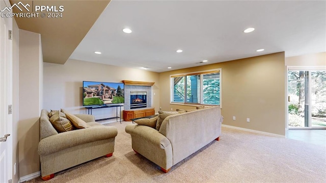 living room with a tiled fireplace and light colored carpet