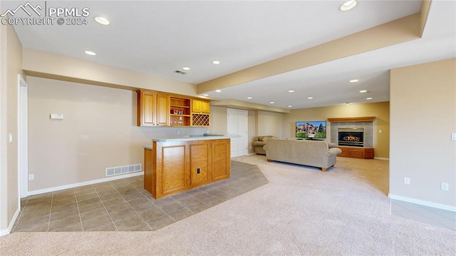 kitchen featuring light carpet and a kitchen island