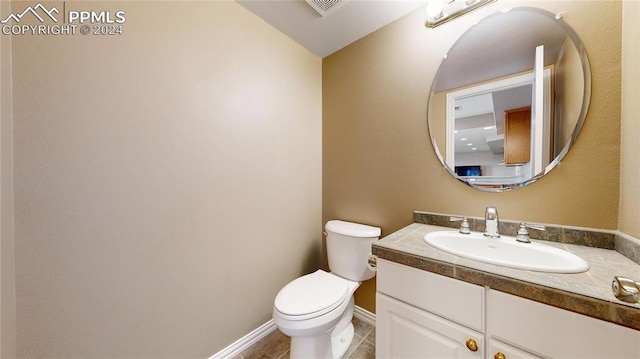 bathroom with vanity, tile patterned flooring, and toilet