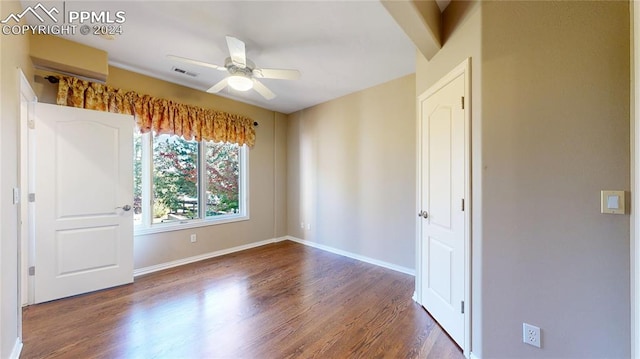 empty room featuring ceiling fan and dark wood-type flooring