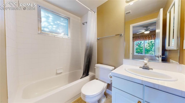 full bathroom with ceiling fan, vanity, shower / bath combo with shower curtain, tile patterned floors, and toilet