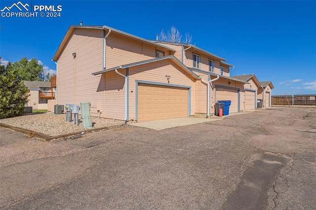 view of side of home featuring a garage