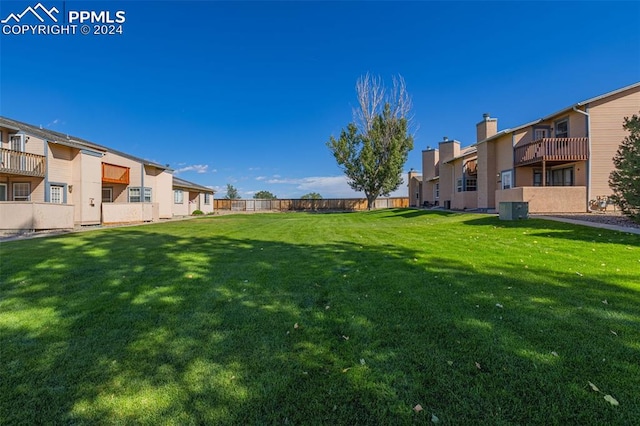 view of yard with a balcony