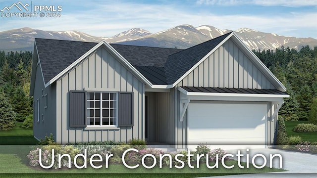 view of front of property featuring a mountain view and a garage