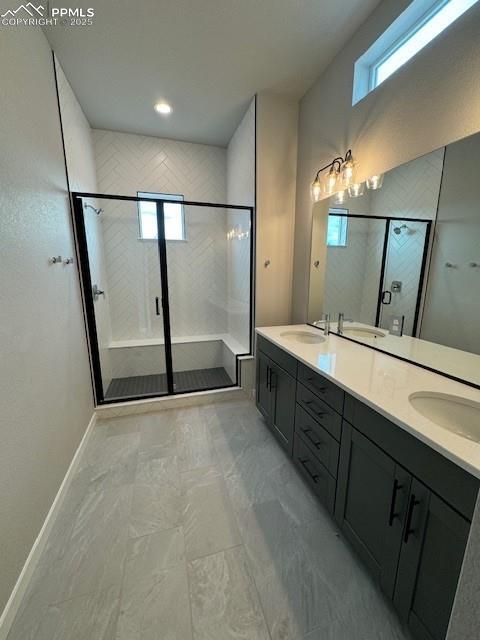 bathroom with vanity and a shower with shower door