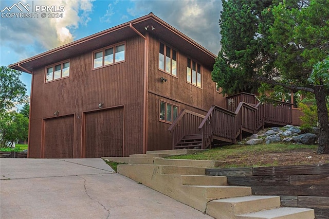 exterior space with a garage and a wooden deck