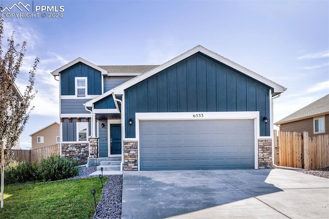 view of front of home featuring a front yard and a garage