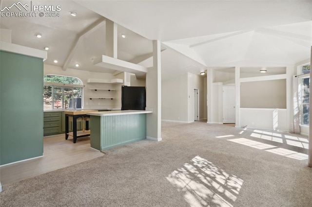 interior space featuring light carpet and vaulted ceiling