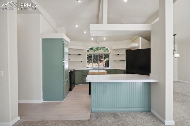 kitchen featuring beamed ceiling, kitchen peninsula, black appliances, light colored carpet, and green cabinets