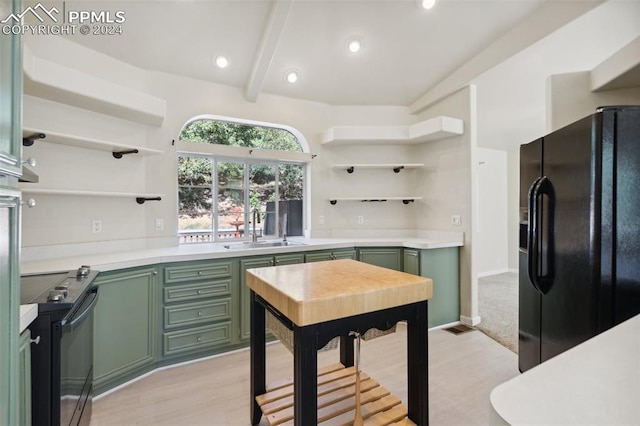 kitchen with light wood-type flooring, sink, stainless steel electric range oven, green cabinets, and black fridge with ice dispenser