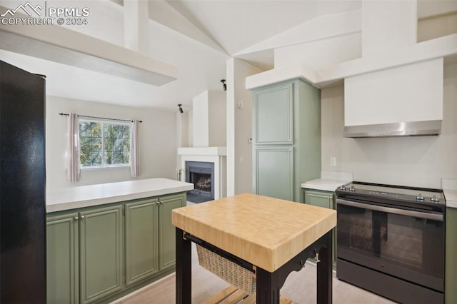 kitchen featuring stainless steel range with electric cooktop, light hardwood / wood-style floors, green cabinets, and vaulted ceiling