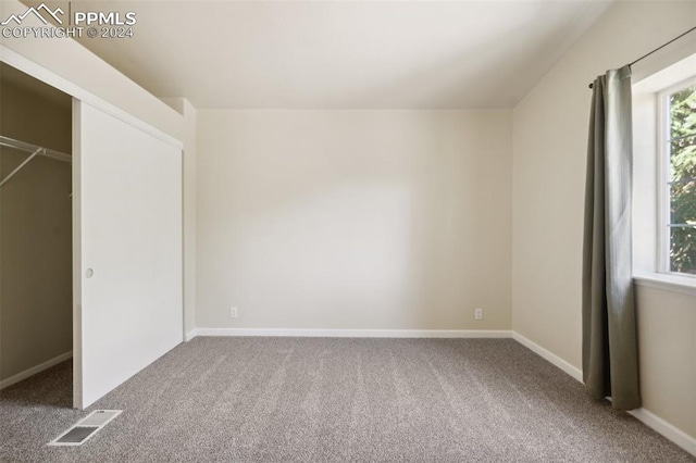 unfurnished bedroom with carpet and a closet