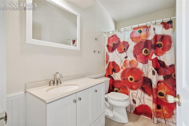 bathroom featuring vanity, hardwood / wood-style floors, toilet, and a shower with shower curtain