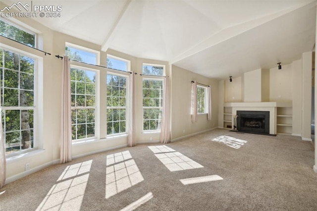 unfurnished living room featuring light carpet and vaulted ceiling with beams