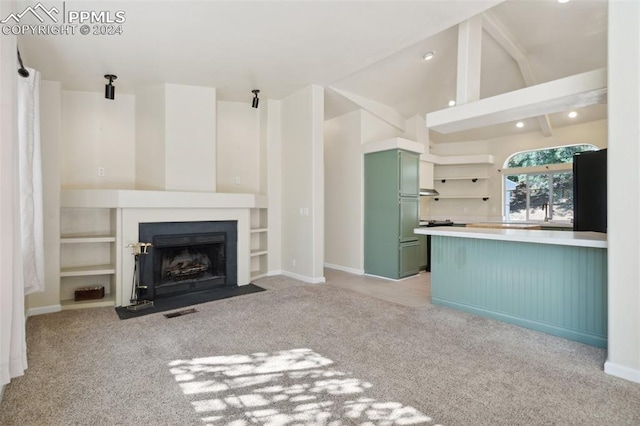 unfurnished living room with light colored carpet and lofted ceiling with beams