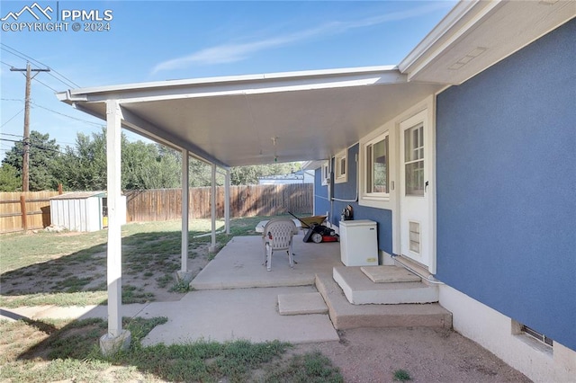 view of patio / terrace featuring a storage unit