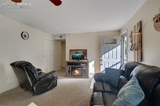 living room featuring ceiling fan and carpet flooring