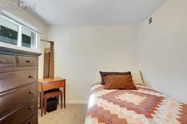 bedroom featuring light carpet