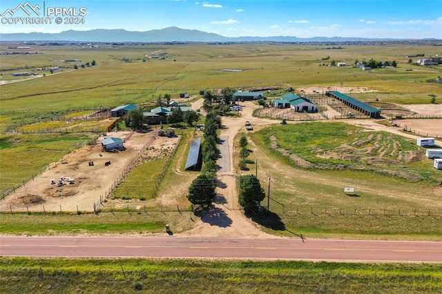 birds eye view of property featuring a mountain view and a rural view