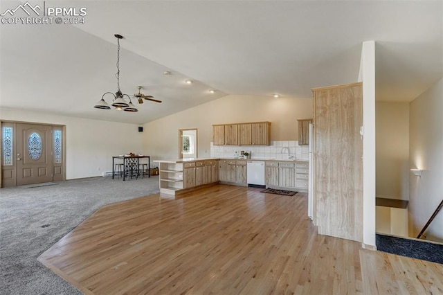 interior space with a healthy amount of sunlight, dishwasher, lofted ceiling, and light brown cabinets