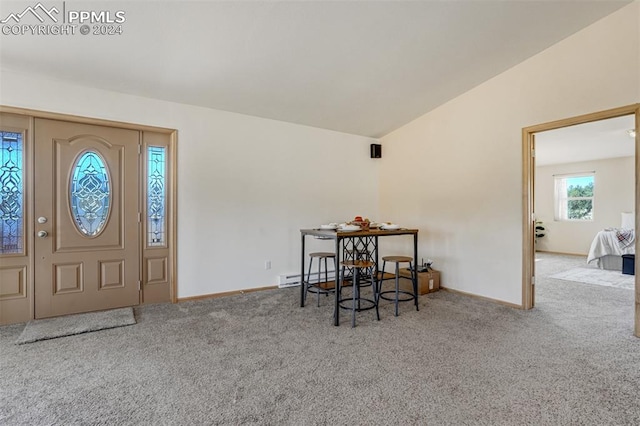 carpeted foyer featuring vaulted ceiling and a baseboard radiator