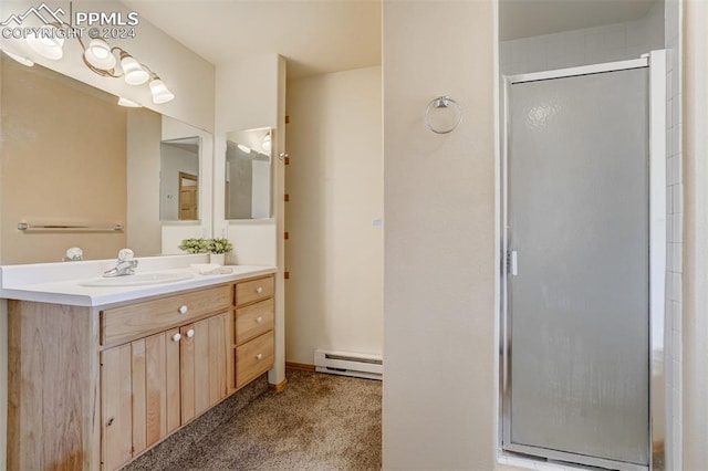 bathroom featuring an enclosed shower, vanity, and a baseboard radiator