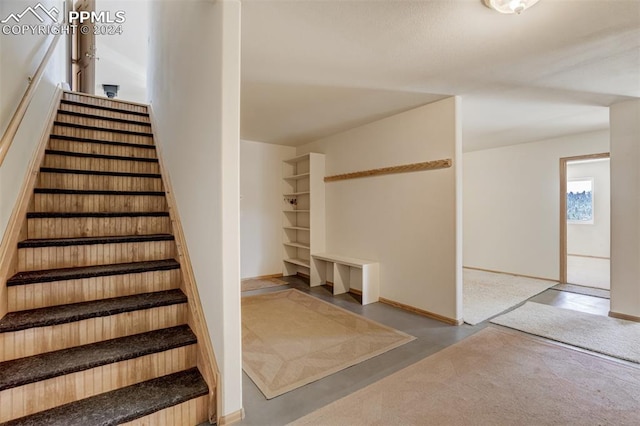 stairway with concrete flooring