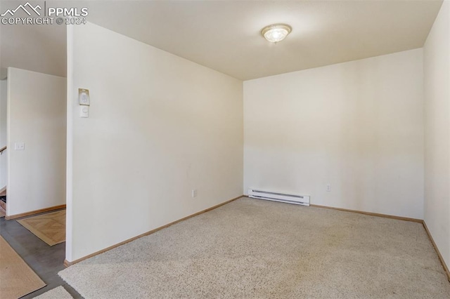 spare room featuring carpet floors and a baseboard radiator