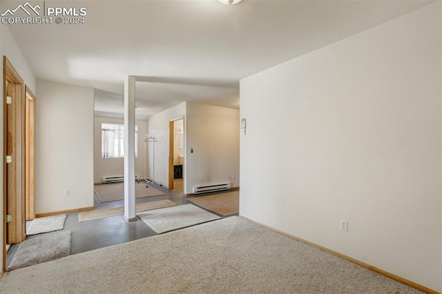 unfurnished room featuring baseboard heating and carpet flooring