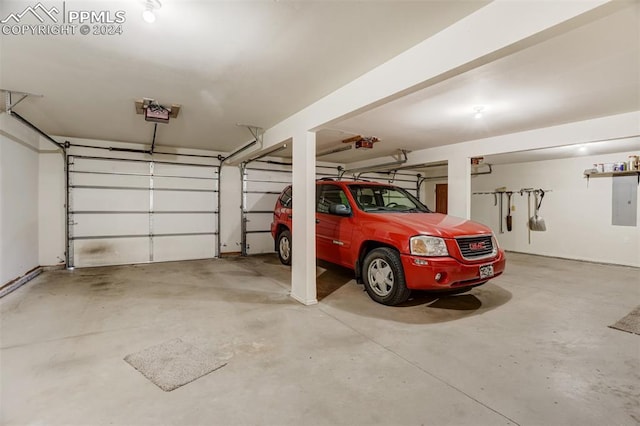 garage featuring a garage door opener and electric panel