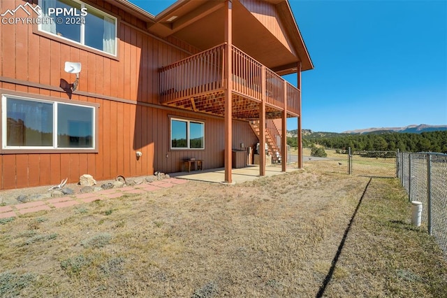 rear view of property featuring a patio and a mountain view