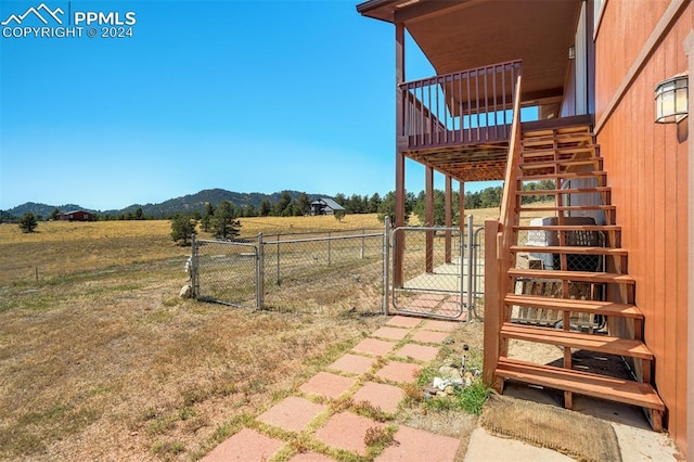 view of yard featuring a mountain view and a rural view