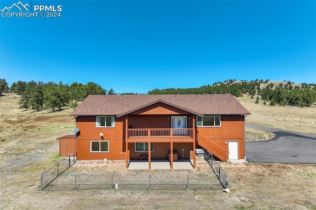 back of property featuring a wooden deck