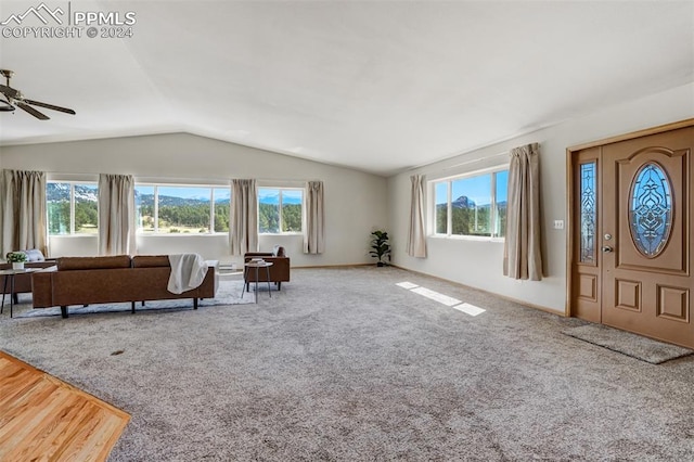 living room featuring carpet, vaulted ceiling, ceiling fan, and a healthy amount of sunlight