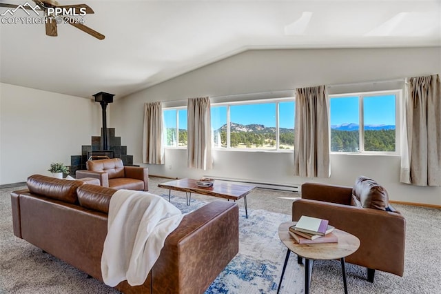 living room featuring a baseboard heating unit, carpet flooring, a wood stove, vaulted ceiling, and ceiling fan