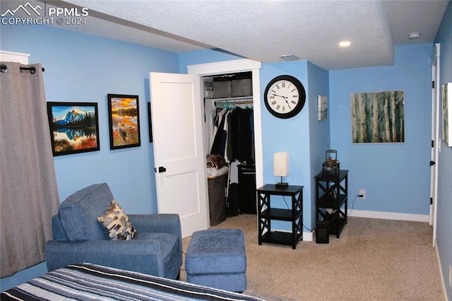 living area with a textured ceiling and light carpet