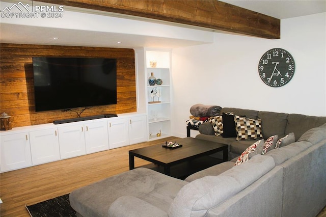 living room with beam ceiling, hardwood / wood-style floors, and built in features