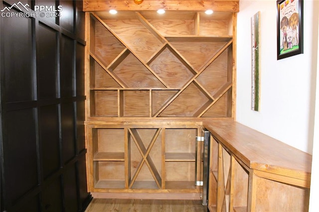 wine room with bar area and hardwood / wood-style flooring