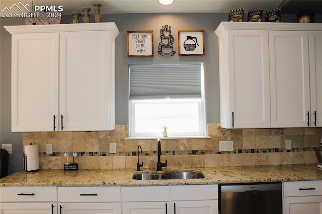 kitchen featuring white cabinetry, sink, tasteful backsplash, and stainless steel dishwasher