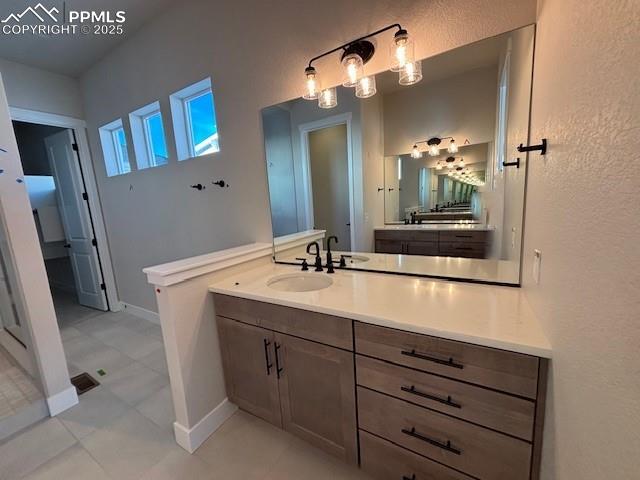 bathroom with vanity and baseboards