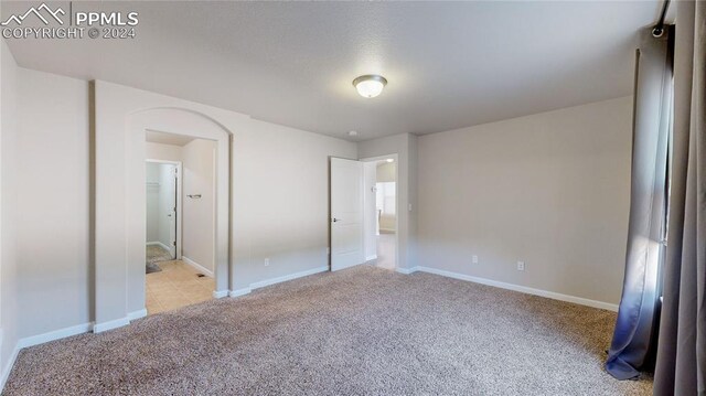 unfurnished bedroom with light colored carpet