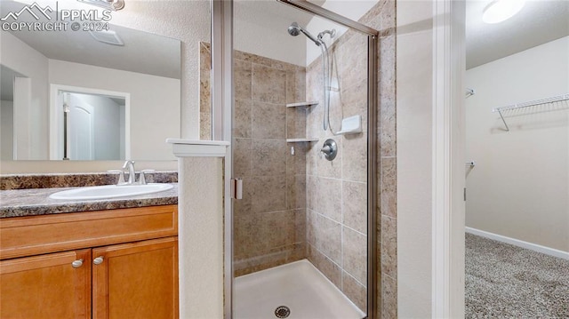 bathroom featuring vanity and a shower with shower door