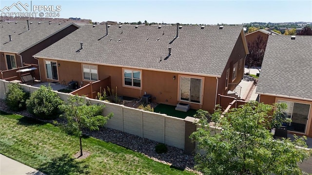 rear view of house with a yard